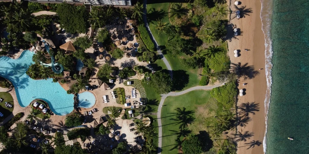 Aerial view of the Kaanapali Coastline showing the beach on the right side and a Kaanapali resort on the left